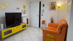 a living room with a television and a couch at Sea Colors Apartment in Montesilvano