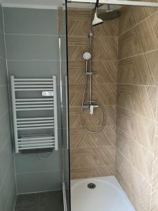 a shower with a glass door in a bathroom at Le Hameau des Lavandes in Roynac +49 photos