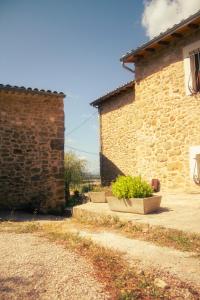 a brick building with two plants in front of it at Le Hameau des Lavandes in Roynac