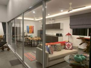 a living room with a couch and a dining room at Villa Natao by SP Villa Management in Mae Nam