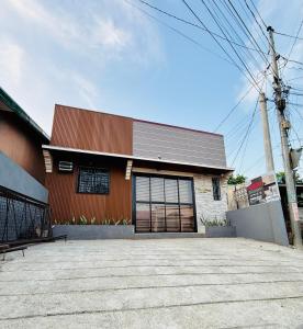 a building with a large garage door at FYLL Homes - Francheska Suite Stylish 1-Bed Apartment with FREE parking in Cavinti Near Hulugan Falls in Cavinti