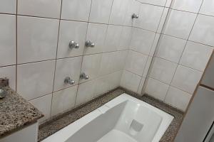 a bathroom with a white toilet in the floor at Espaçoso apartamento perto Centro Sul e hospitais in Florianópolis +3 photos