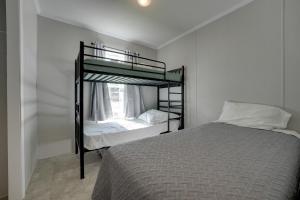 a bedroom with two bunk beds and a window at Cassopolis Cabin with On-Site Fishing Pier! in Cassopolis +32 photos