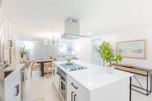 a kitchen with white countertops and a dining room at Magnificent Beach Front Condo - Flagler Ave - 111 in New Smyrna Beach
