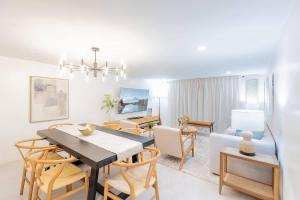 a dining room and living room with a table and chairs at Magnificent Beach Front Condo - Flagler Ave - 111 in New Smyrna Beach