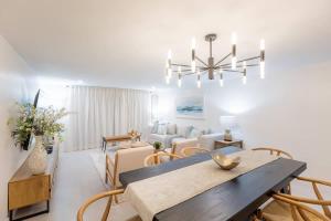 a dining room and living room with a table and chairs at Magnificent Beach Front Condo - Flagler Ave - 111 in New Smyrna Beach +21 photos