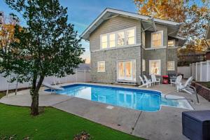 a house with a swimming pool in front of a house at Southern Tides- Pool, Fire Pit & Games in Birmingham