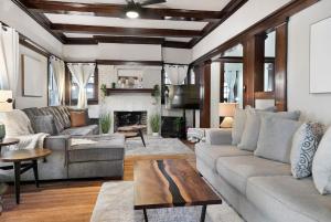 a living room with a couch and a fireplace at Southern Tides- Pool, Fire Pit & Games in Birmingham