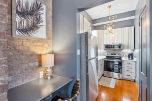 a kitchen with a white refrigerator and a counter at Beautiful Renovated Apartment One Block from King in Charleston