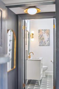 a bathroom with a sink and a toilet at Beautiful Renovated Apartment One Block from King in Charleston +7 photos