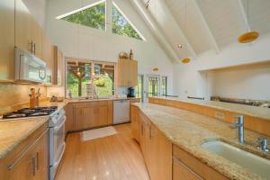 a large kitchen with wooden cabinets and a large window at Banner Elk Valley Overlook in Banner Elk +49 photos