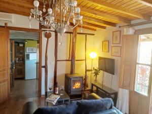 a living room with a couch and a wood stove at Alojamientos La Herrera in San Esteban de la Sierra