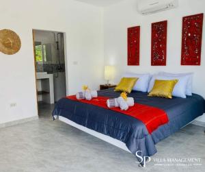 a bedroom with a bed with stuffed animals on it at Villa Noi By Sp Villa Management in Koh Samui 