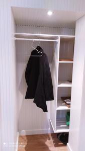 a black shirt is hanging in a closet at Cozy central flat with terrace in Hinge