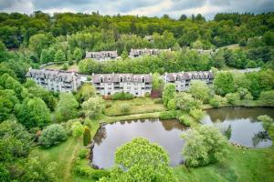 an aerial view of a mansion with a pond at Chetola: Sierra 1 in Blowing Rock