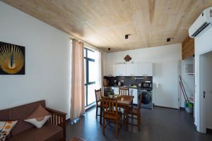 a kitchen and living room with a table and chairs at Tropical apartments in The Soul 400m from Paje beach - Managed by KSN in Paje