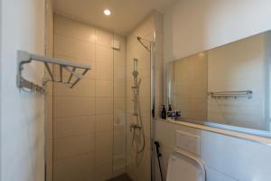 a bathroom with a shower and a toilet and a mirror at Tropical apartments in The Soul 400m from Paje beach - Managed by KSN in Paje