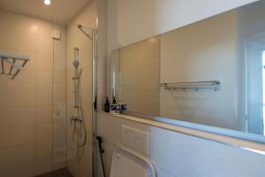a bathroom with a shower and a sink and a toilet at Tropical apartments in The Soul 400m from Paje beach - Managed by KSN in Paje