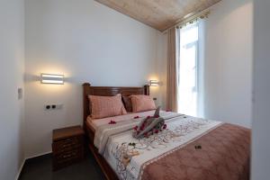 a bedroom with a bed with pink pillows and a window at Tropical apartments in The Soul 400m from Paje beach - Managed by KSN in Paje +113 photos