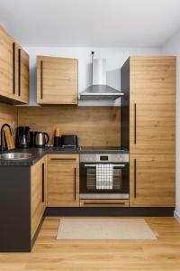 a kitchen with wooden cabinets and a stove top oven at Moderne Wohnung in Siegen in Siegen