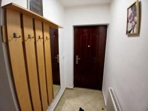 a hallway with two doors and a cat sitting next to it at Stan na dan-Vasilije in Zvornik +3 photos