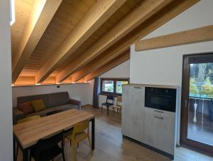 a living room with a couch and a table at Chalet Serenella in Valdidentro
