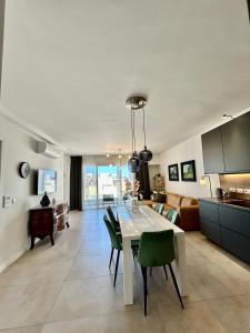 a kitchen and living room with a table and chairs at Luxury Private Suite & Room St Julians Central - Shared Apt in Is-Swieqi