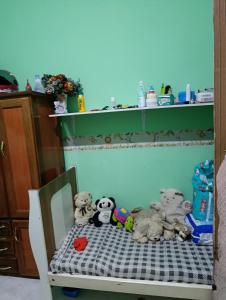 a group of stuffed animals sitting on a crib at Casa para alugar na cop30 in Ananindeua