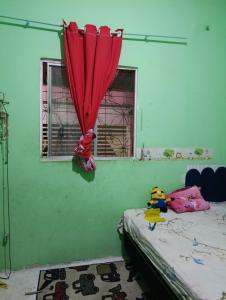 a room with a bed and a red umbrella at Casa para alugar na cop30 in Ananindeua