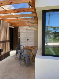 a table and chairs on a patio with a ceiling at Las Olas Miramar in Miramar