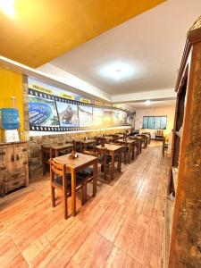 a dining room with wooden tables and a baseball mural at Pousada Recanto de Figueira in Arraial do Cabo +14 photos