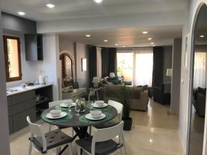 a kitchen and living room with a table and chairs at La Manga Club, Las Palmeras 12 in Cartagena