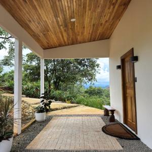 an entrance to a house with a wooden ceiling at Jungle Bungalow at Oropel Lodge in Puerto Viejo +40 photos