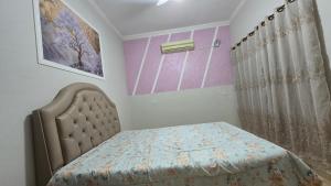 a bedroom with a bed and a curtain at Casa aconchegante 4 minutos do thermas in Andradina
