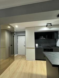a kitchen with white cabinets and a counter top at Cuza Residence in Craiova +6 photos