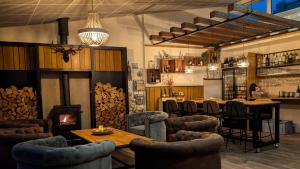 a bar with chairs and a fireplace in a room at 11Stedenhuis in Rijs