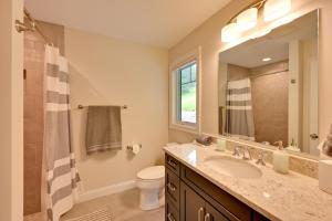 a bathroom with a sink and a toilet and a mirror at Ski In and Out! Black Mountain Resort Townhome in Jackson +26 photos