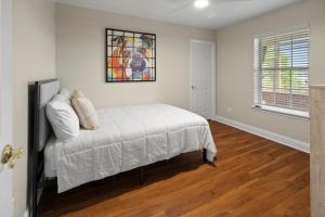 a bedroom with a bed and a painting on the wall at Riverfront Escape! Private Pier, 4 BR Home and Room to Entertain in Jacksonville