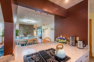 a kitchen with a stove top oven in a room at Panorama Point - Sauna, hot tub, theater room in Davis