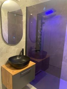 a bathroom with a black sink and a shower at 3 zimmer Apartment in Lörrach