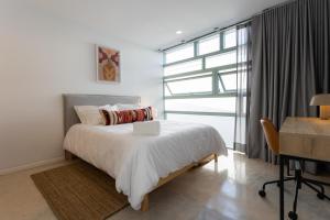 Ένα ή περισσότερα κρεβάτια σε δωμάτιο στο Outsite Oaxaca City - Work, Connect, Explore