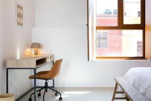 a bedroom with a desk and a bed and a window at Outsite Oaxaca City - Work, Connect, Explore in Oaxaca City +8 photos