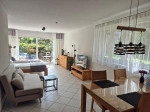 a living room with a bed and a dining room at Ferienwohnung Hirsch in Sinzheim