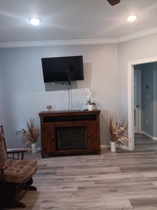 a living room with a flat screen tv on a wall at Ben Cabin in Natchitoches