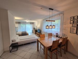 a living room with a bed and a dining table at Ferienwohnung Hirsch in Sinzheim