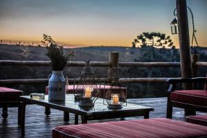 a table with candles and a vase on a patio at Parador Cambará do Sul in Cambara do Sul
