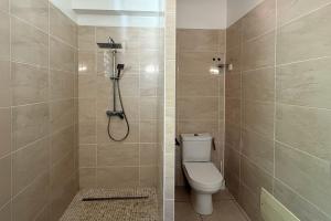 a bathroom with a toilet and a shower at Perle d'Arlet in Les Anses-dʼArlets +6 photos