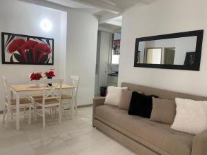 a living room with a couch and a table at Apartamento Playas de Marbella in Cartagena de Indias