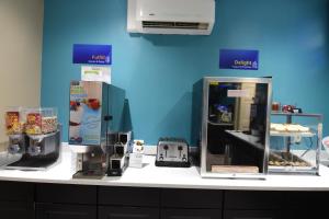 a counter with two refrigerators on a blue wall at Best Western Point South in Yemassee