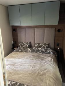 a bedroom with a large bed with a large headboard at La vie slow 336 in Monterblanc